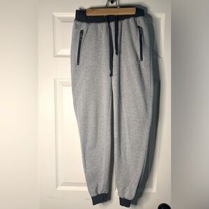 WOMEN’S joggers. Gray with navy trim, two zip up pockets, medium.